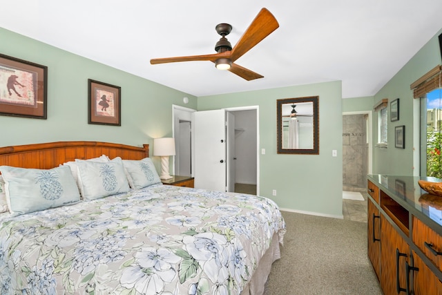 bedroom with a spacious closet, light colored carpet, and ceiling fan