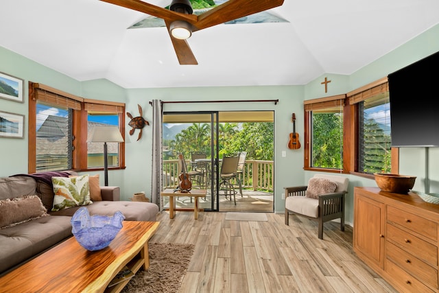 sitting room featuring light hardwood / wood-style flooring, vaulted ceiling, and ceiling fan