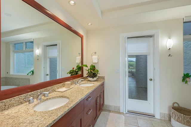 bathroom with vanity, a bath, and tile patterned flooring