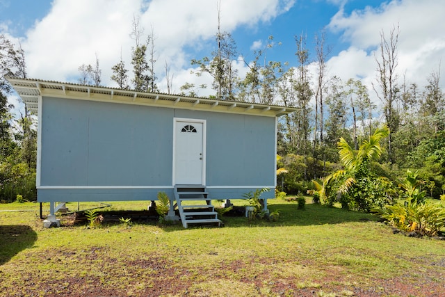 view of outbuilding featuring a lawn