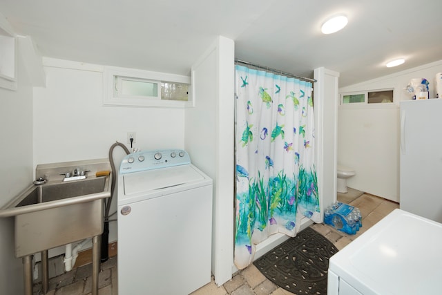 laundry area featuring sink and washer / dryer