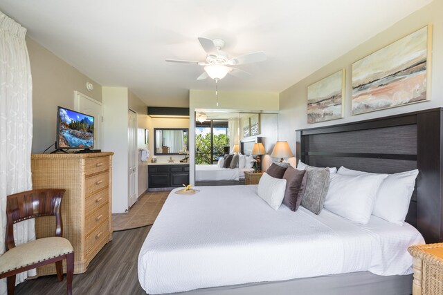 bedroom featuring ensuite bathroom, dark hardwood / wood-style floors, and ceiling fan