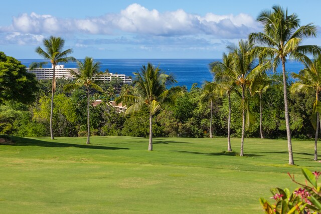 view of home's community featuring a water view and a lawn