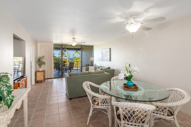 dining space with ceiling fan and tile patterned floors