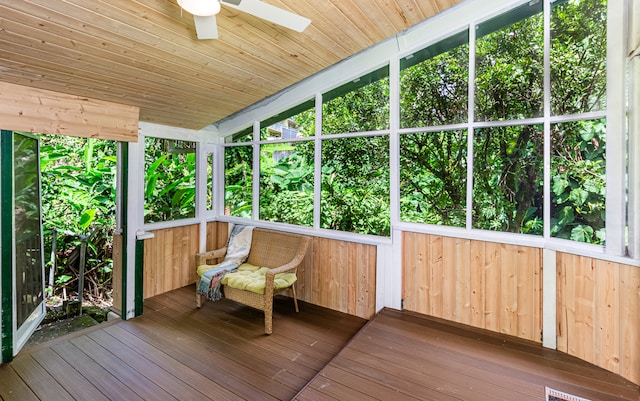 unfurnished sunroom with ceiling fan and wooden ceiling