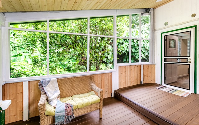 unfurnished sunroom featuring vaulted ceiling and wooden ceiling