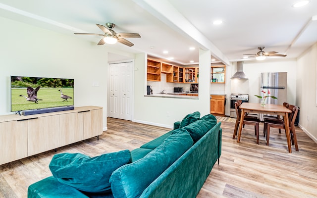 living room featuring light wood-type flooring and ceiling fan