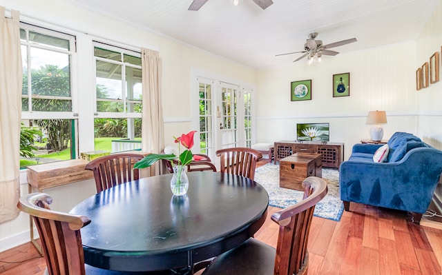 dining area with ceiling fan, french doors, and wood-type flooring