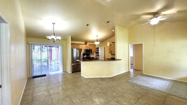 kitchen featuring appliances with stainless steel finishes, ceiling fan with notable chandelier, kitchen peninsula, pendant lighting, and high vaulted ceiling