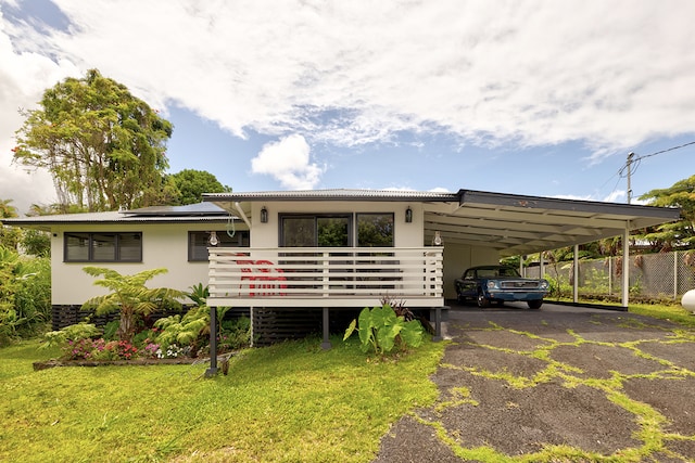 exterior space featuring a front lawn and a carport