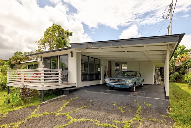 view of parking / parking lot featuring a carport