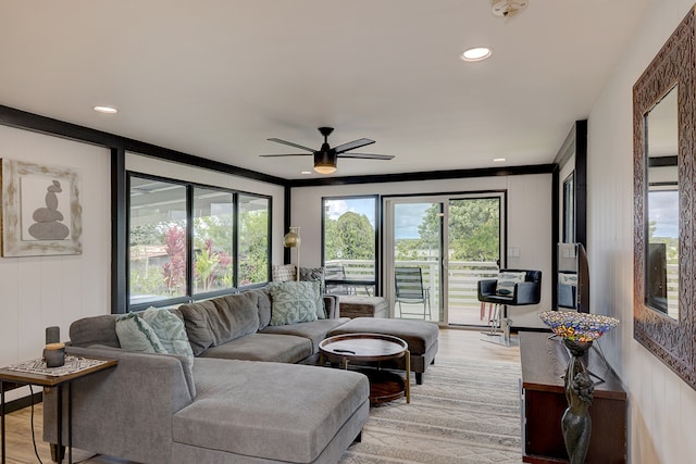 living room with ceiling fan and light hardwood / wood-style flooring