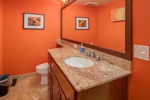 bathroom with visible vents, baseboards, toilet, and vanity