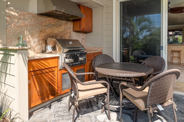 view of patio / terrace with a grill, exterior kitchen, and outdoor dining area