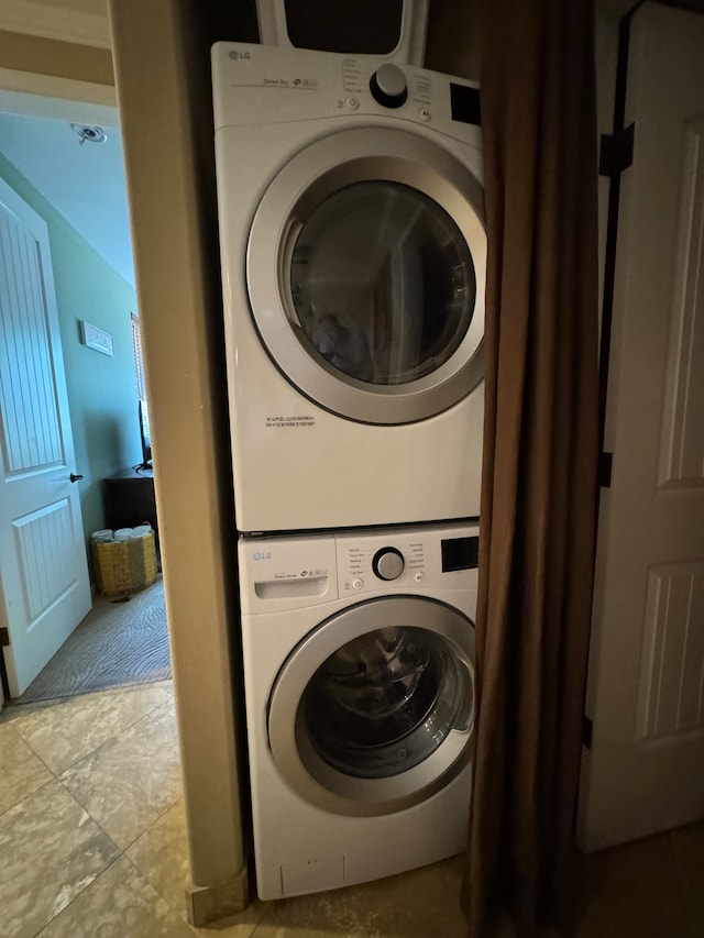 laundry room with stacked washer / dryer