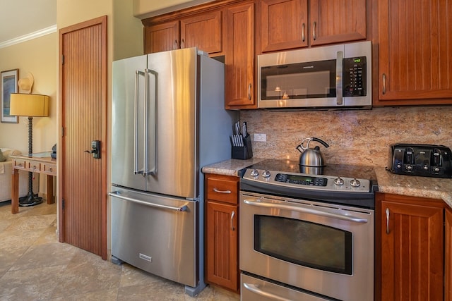 kitchen featuring tasteful backsplash, appliances with stainless steel finishes, brown cabinetry, and crown molding