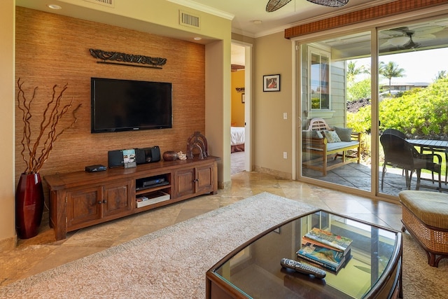 living room with crown molding, a ceiling fan, visible vents, and baseboards