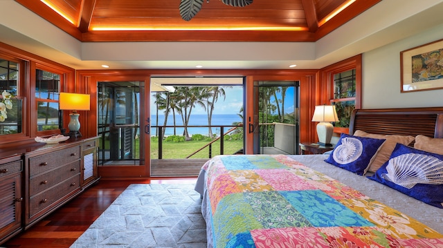 bedroom with access to outside, a tray ceiling, dark wood-type flooring, and wood ceiling