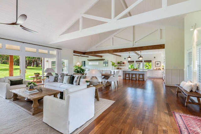 living room with ceiling fan, wood-type flooring, beam ceiling, and high vaulted ceiling