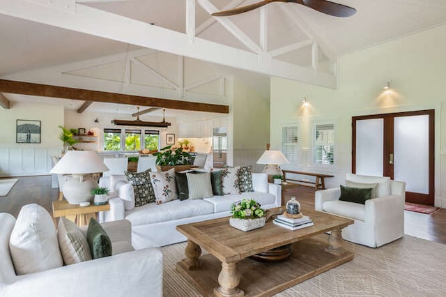 living room with ceiling fan, french doors, beam ceiling, and high vaulted ceiling