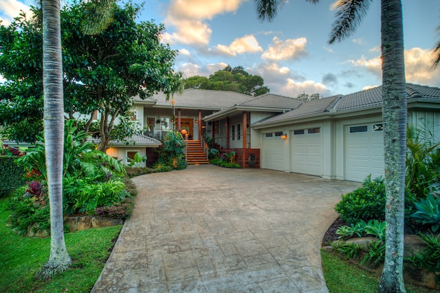 view of front of house featuring a porch and a garage