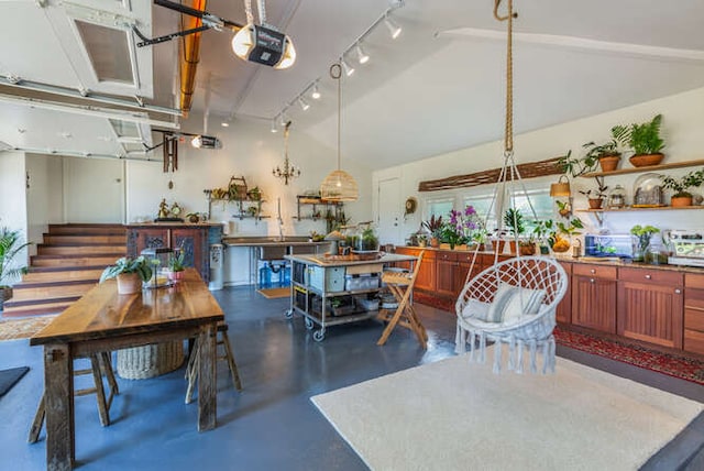 dining area featuring lofted ceiling and rail lighting