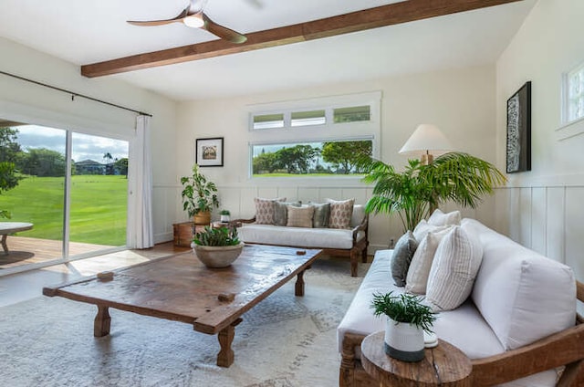 living room with beam ceiling, ceiling fan, and a wealth of natural light