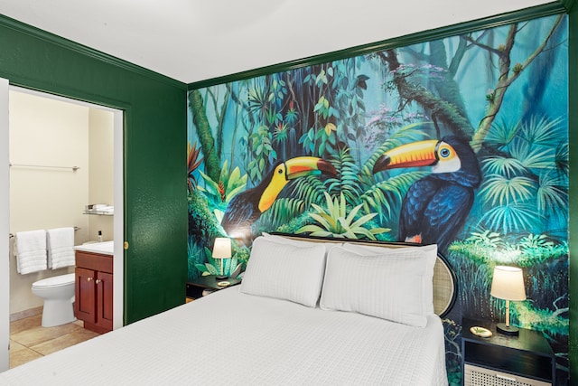 tiled bedroom featuring ensuite bath and crown molding