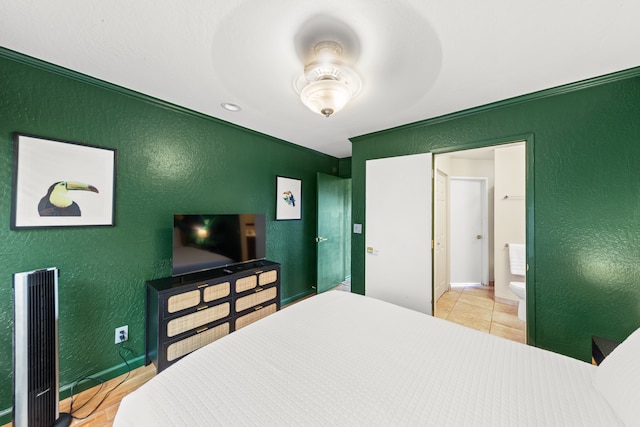 bedroom with ceiling fan, ensuite bath, and tile patterned floors