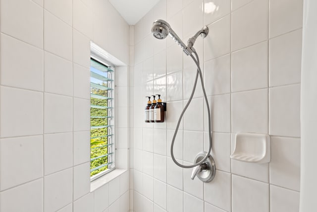 bathroom with tiled shower