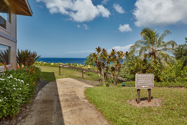 surrounding community with a lawn and a water view