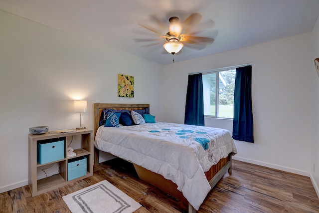 bedroom with hardwood / wood-style floors and ceiling fan