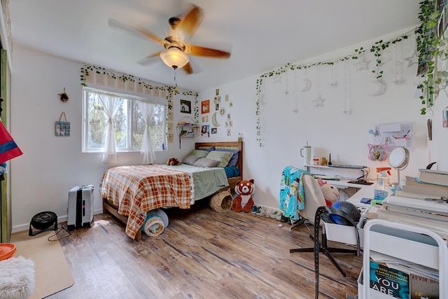 bedroom featuring hardwood / wood-style floors and ceiling fan