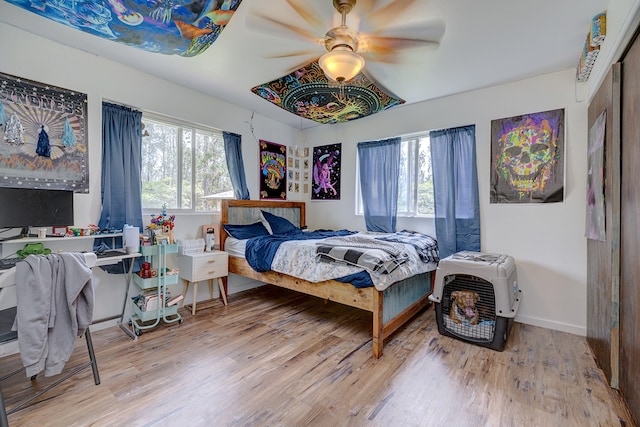 bedroom with ceiling fan and hardwood / wood-style flooring