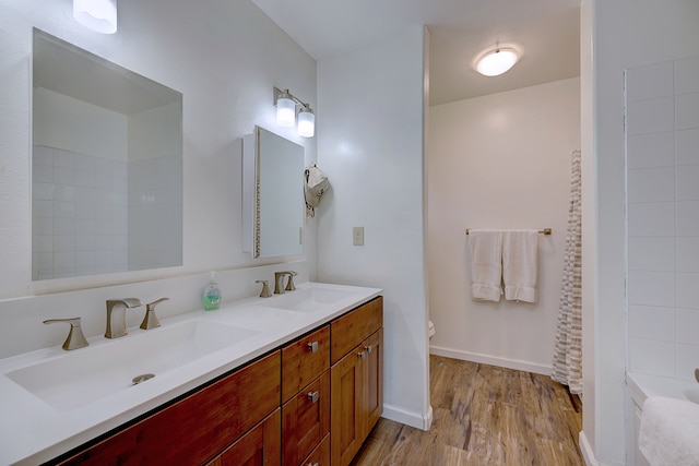 bathroom featuring vanity, toilet, and hardwood / wood-style flooring