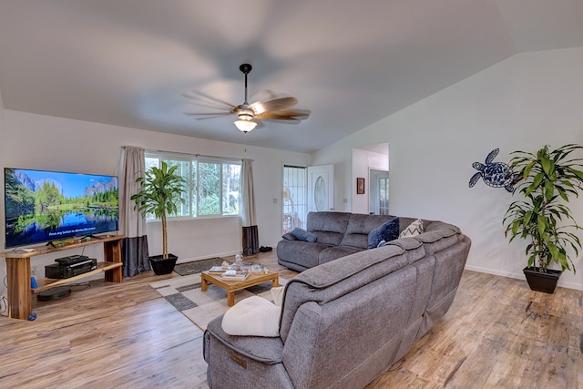 living room featuring ceiling fan, lofted ceiling, and light hardwood / wood-style floors