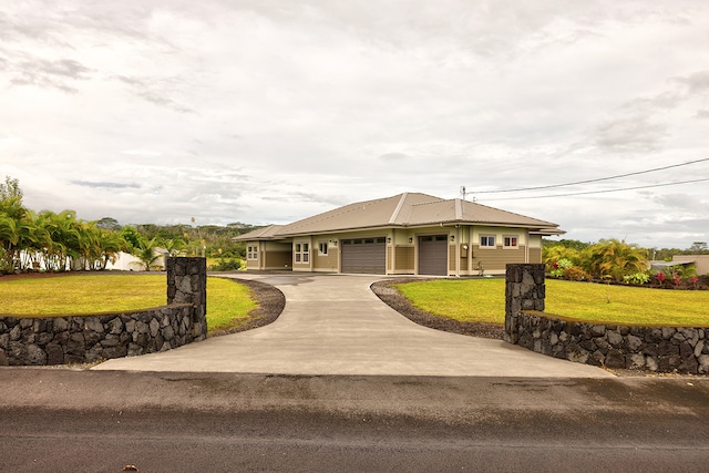 view of front of property featuring a front lawn and a garage