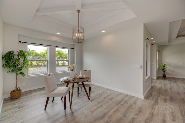 dining space with light hardwood / wood-style floors, an inviting chandelier, and beamed ceiling