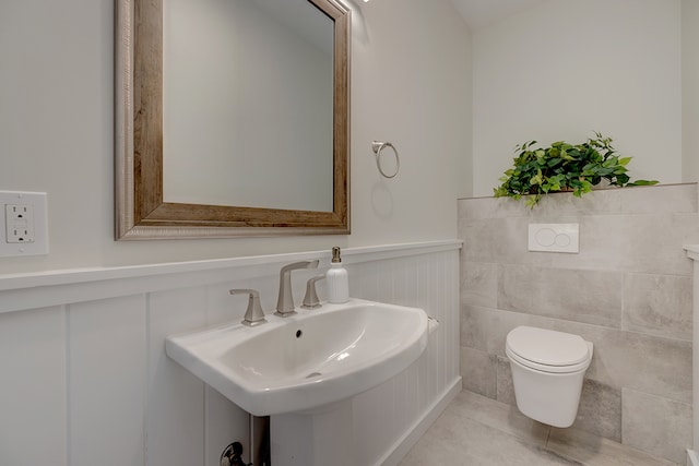 bathroom featuring tile walls, tile patterned floors, sink, and toilet