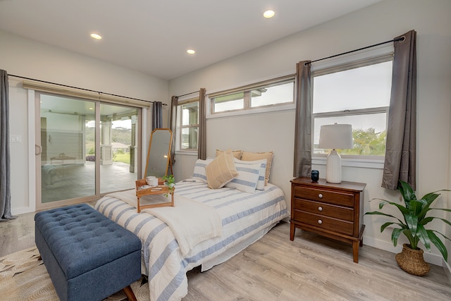 bedroom with light hardwood / wood-style floors and access to outside