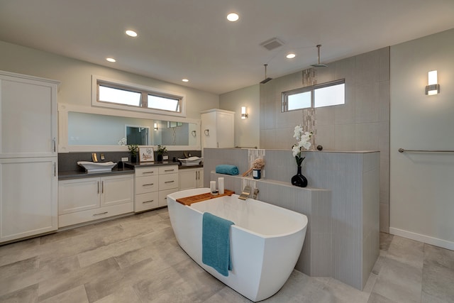 bathroom with vanity, tile walls, and plus walk in shower