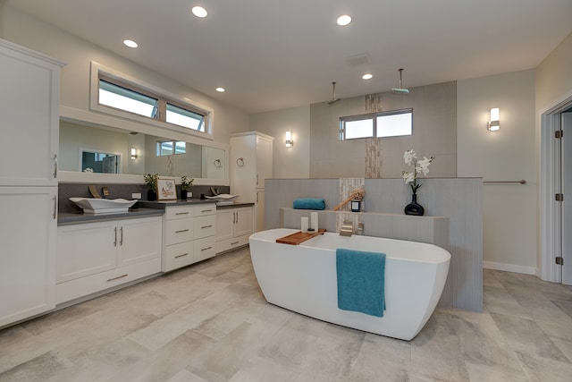 bathroom featuring vanity and separate shower and tub