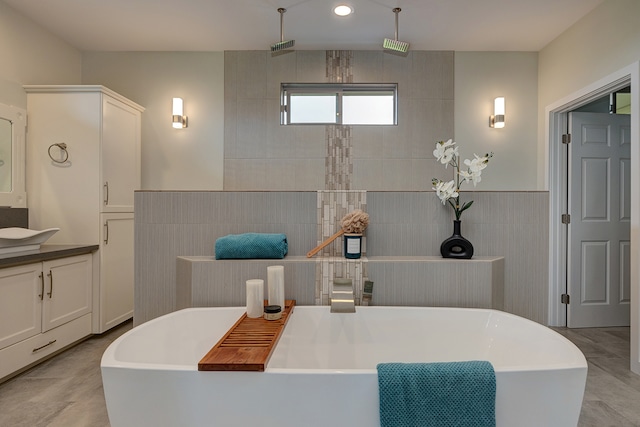 bathroom with tile walls, vanity, plus walk in shower, and tile patterned floors