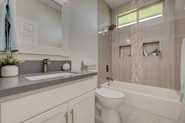 full bathroom featuring vanity, toilet, tiled shower / bath combo, and tile patterned flooring