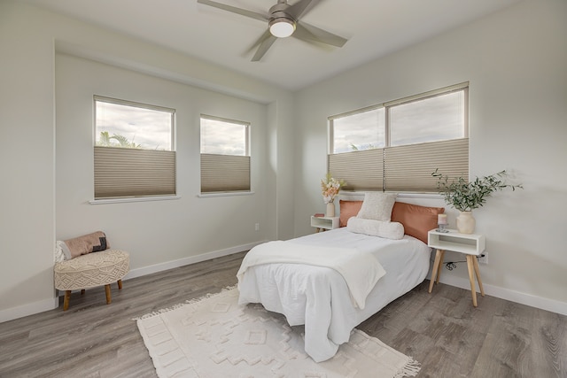 bedroom with hardwood / wood-style floors and ceiling fan