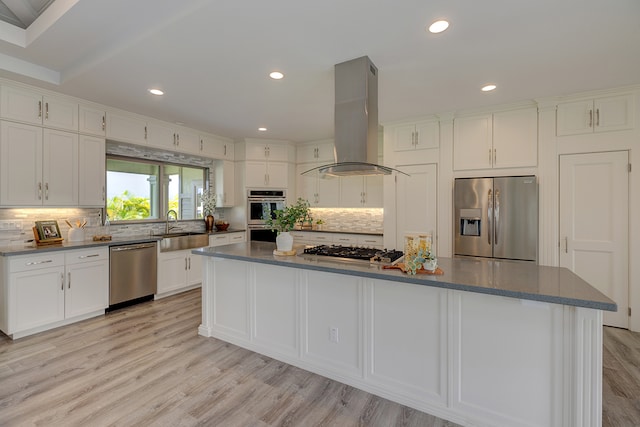 kitchen featuring sink, island range hood, a center island, light hardwood / wood-style floors, and stainless steel appliances