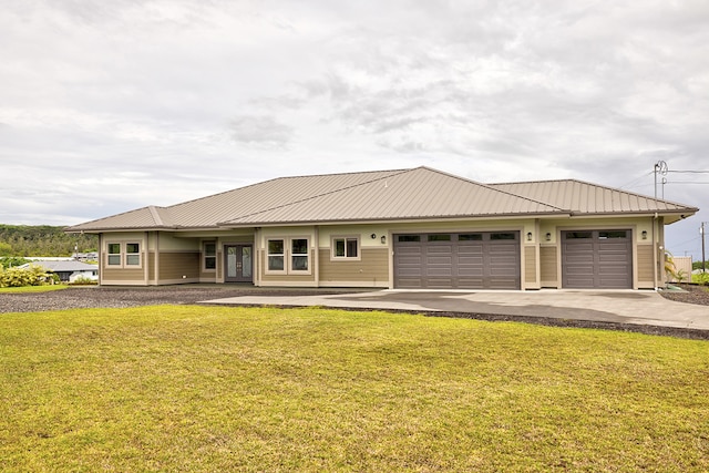 view of front of home with a front lawn and a garage