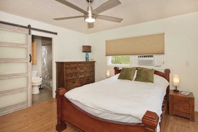 bedroom with ceiling fan, hardwood / wood-style flooring, and a textured ceiling