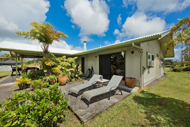 rear view of house featuring a patio, cooling unit, and a yard