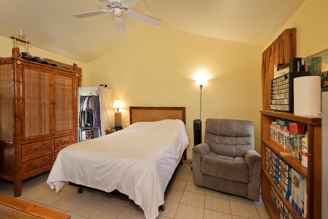 tiled bedroom with ceiling fan and vaulted ceiling